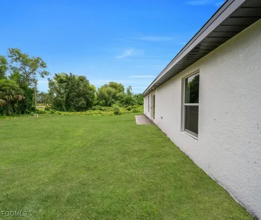 a view of a house with a backyard
