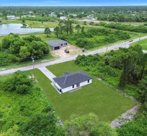 an aerial view of a house with a yard