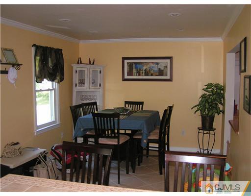 104 Pleasant Valley Road Old Bridge, NJ 08857 - Photo 5 of 7 a view of a dining room with furniture and wooden floor
