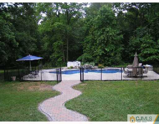 104 Pleasant Valley Road Old Bridge, NJ 08857 - Photo 6 of 7 a view of table and chairs under an umbrella