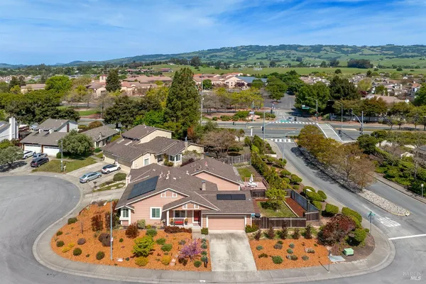 an aerial view of residential houses with outdoor space and river