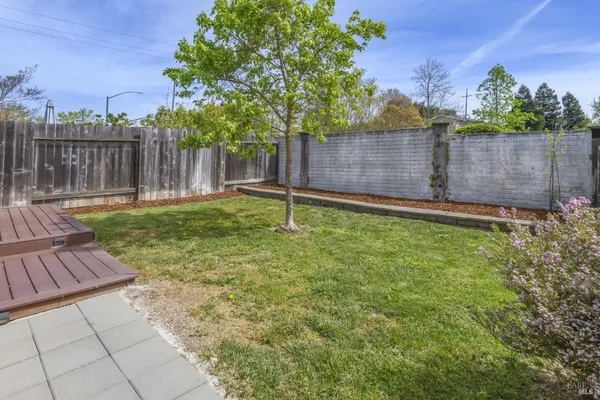 a backyard with wooden fence and a bench