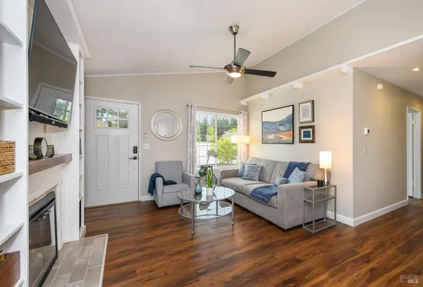 a living room with furniture a fireplace and a window