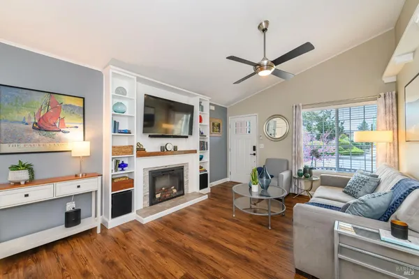 a living room with furniture fireplace and flat screen tv
