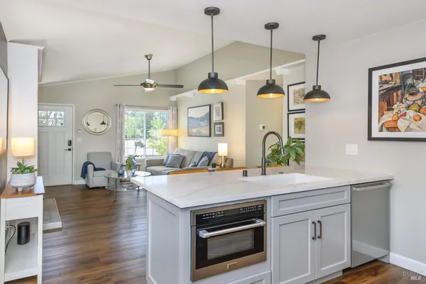 a kitchen view with living room and stove