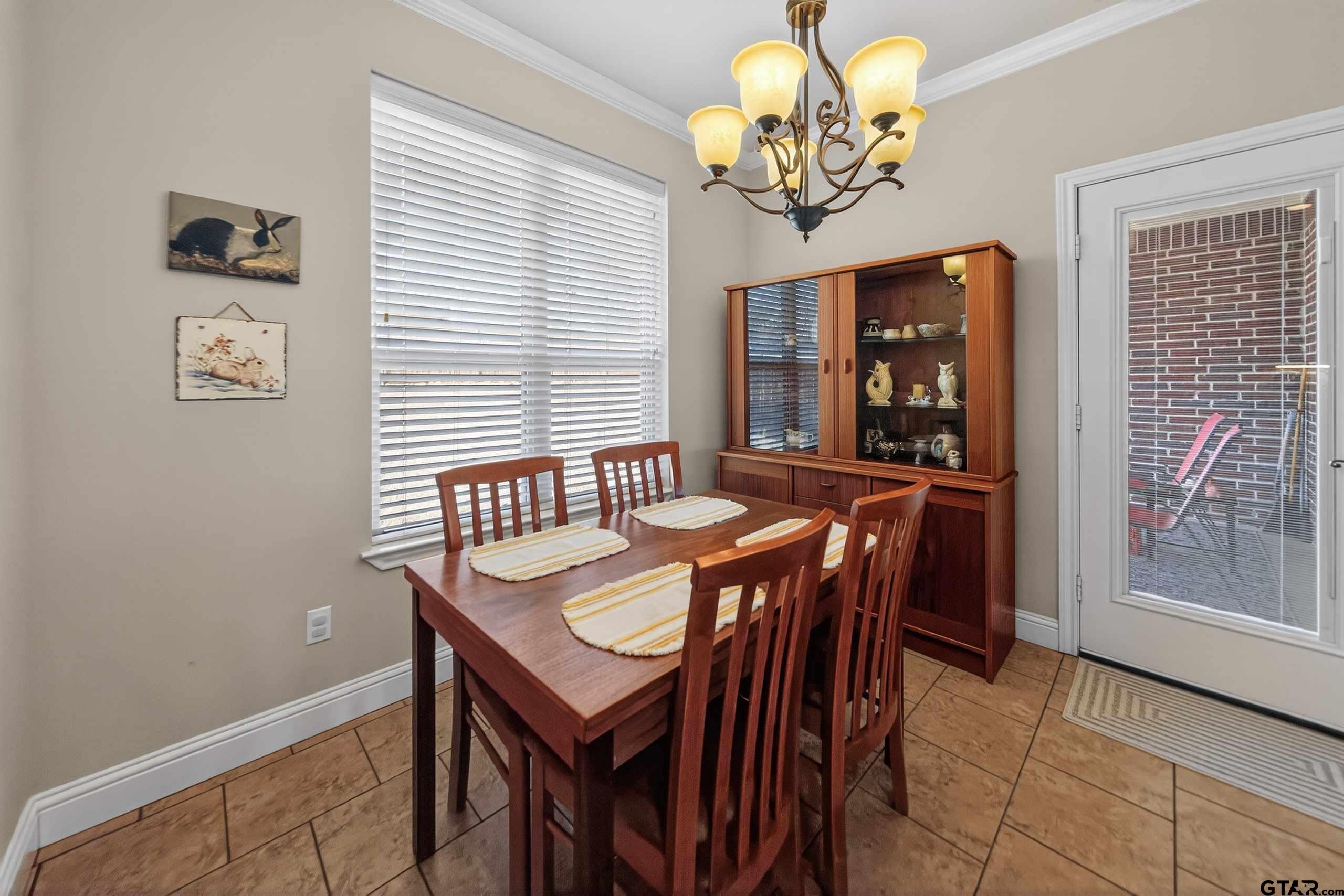 5830 Thompson Place Tyler, TX 75707 - Photo 11 of 35 a view of a dining room with furniture and chandelier