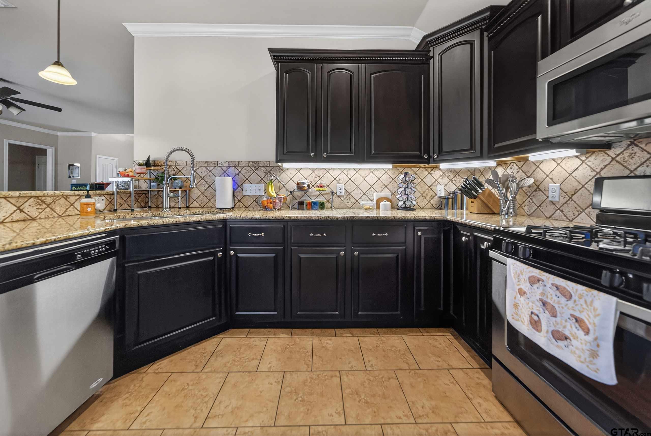 5830 Thompson Place Tyler, TX 75707 - Photo 14 of 35 a kitchen with a sink and cabinets
