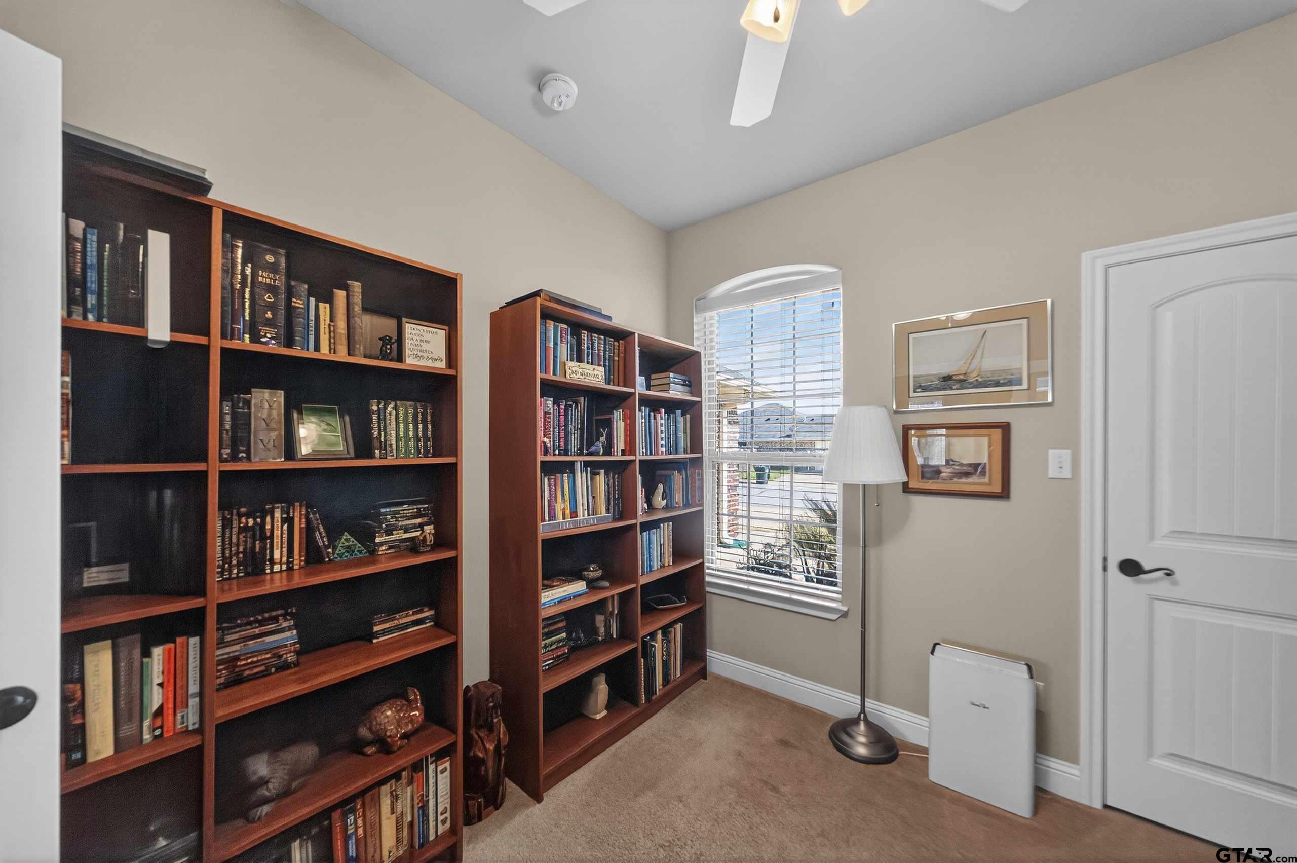 5830 Thompson Place Tyler, TX 75707 - Photo 17 of 35 a view of a book shelf with lots of books