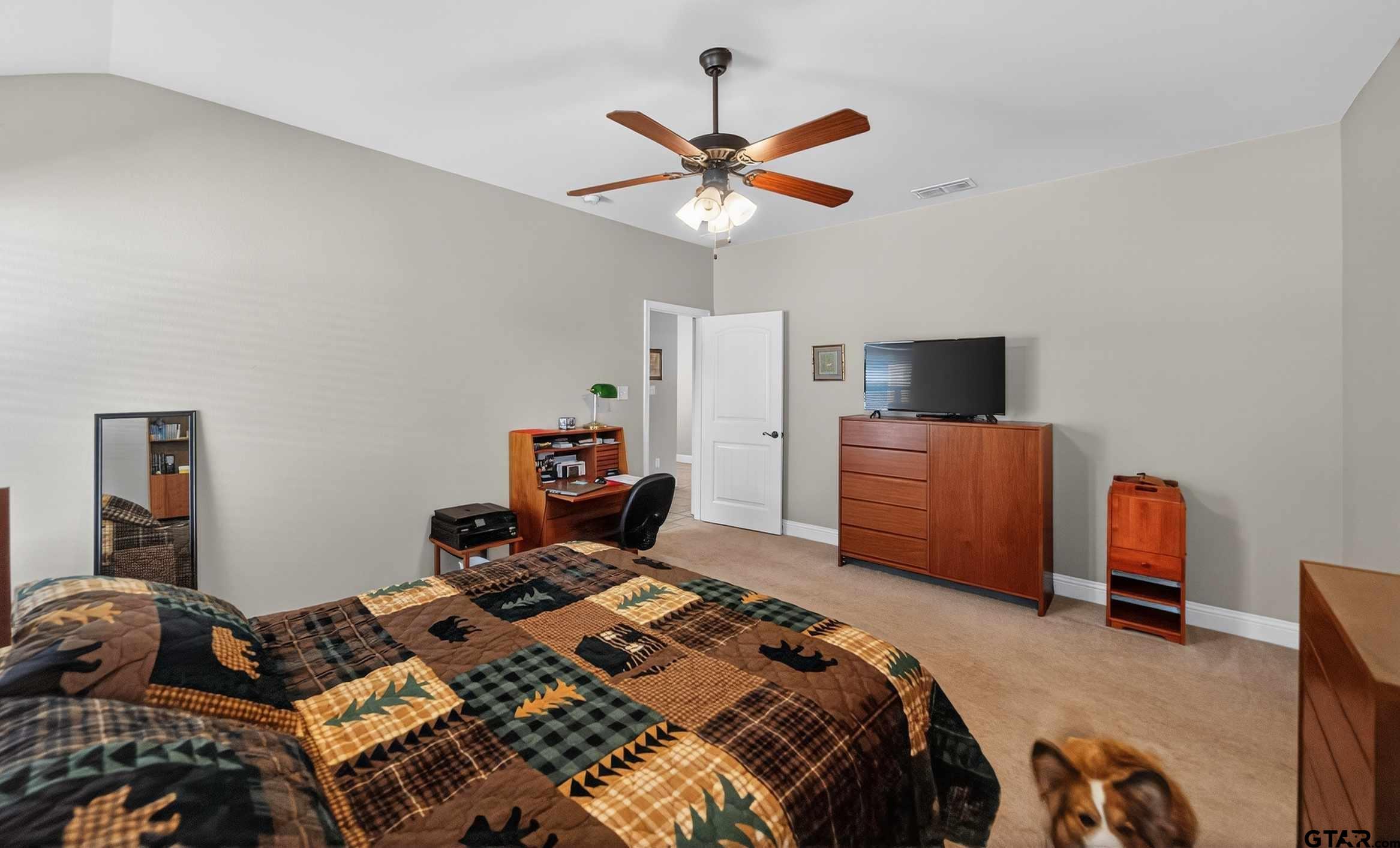 5830 Thompson Place Tyler, TX 75707 - Photo 20 of 35 a bed room with a bed and a chandelier