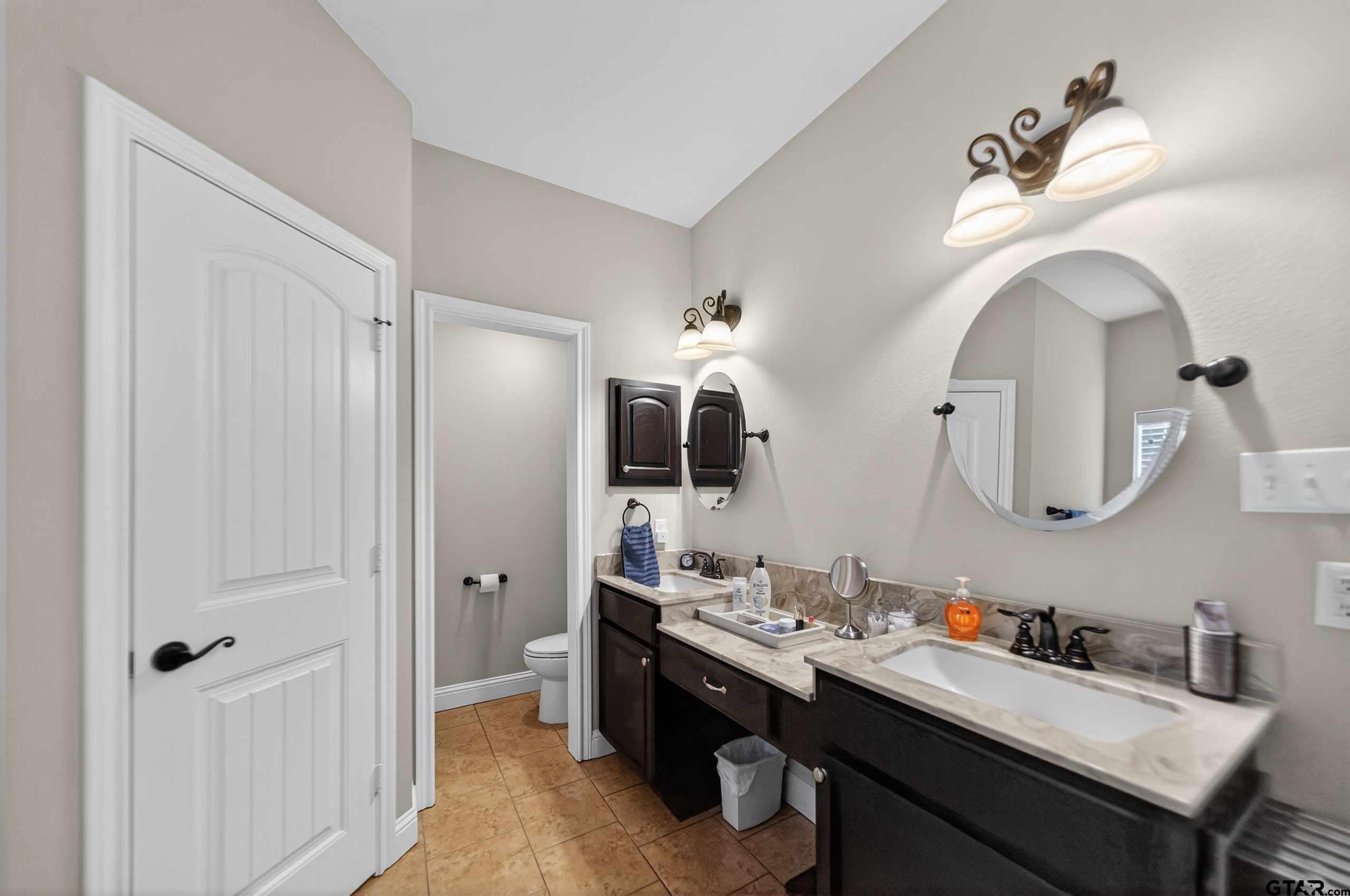 5830 Thompson Place Tyler, TX 75707 - Photo 22 of 35 a bathroom with a double vanity sink and a mirror