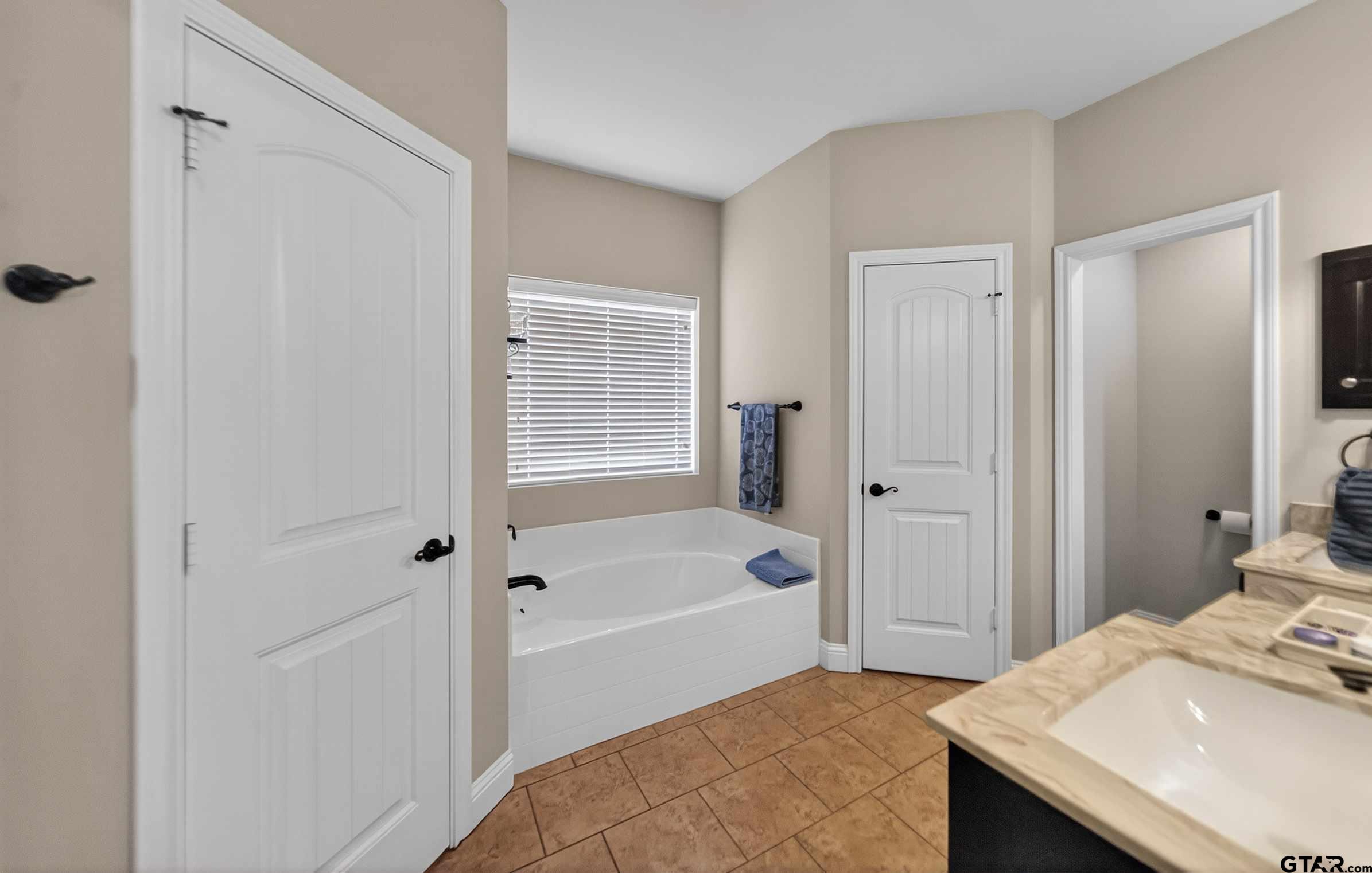 5830 Thompson Place Tyler, TX 75707 - Photo 24 of 35 a bathroom with a sink a toilet and shower