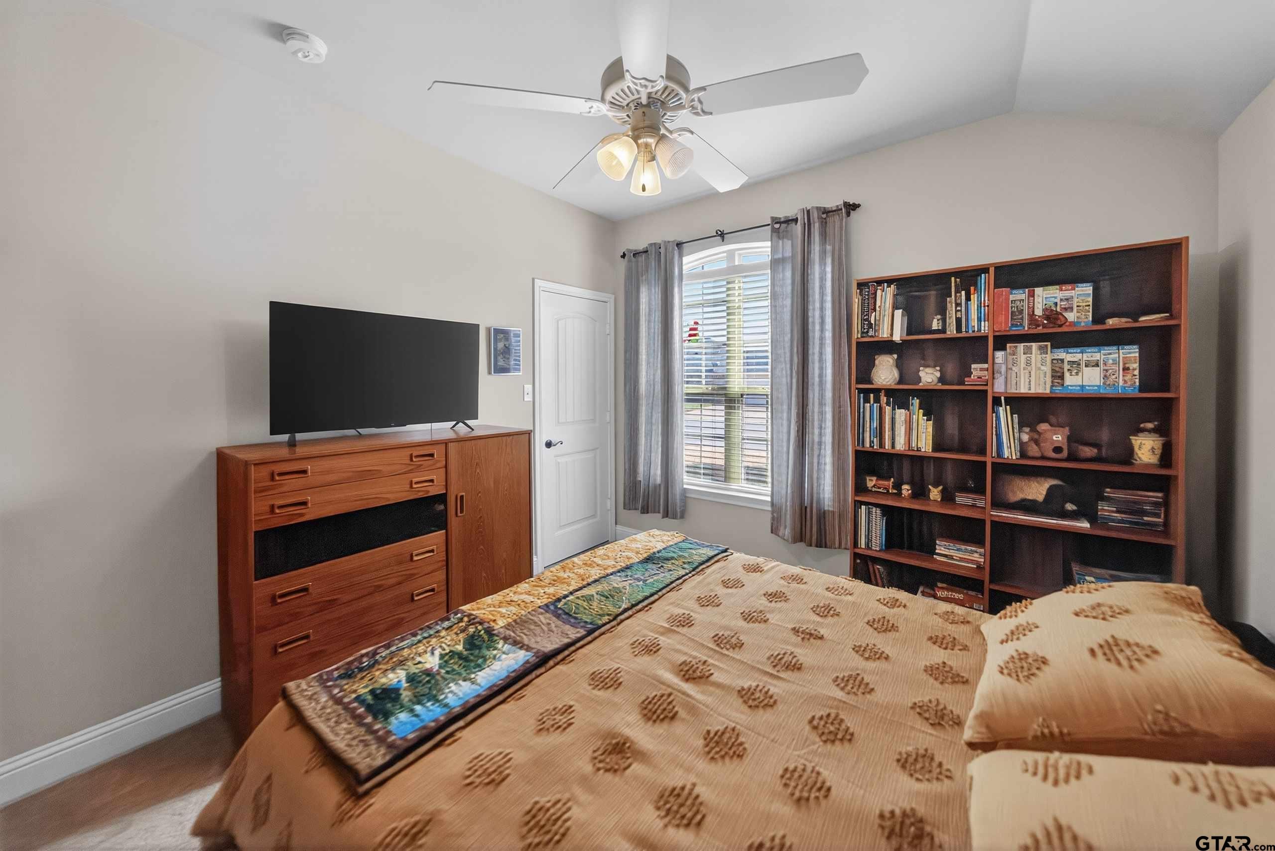 5830 Thompson Place Tyler, TX 75707 - Photo 27 of 35 a bedroom with furniture and a flat screen tv