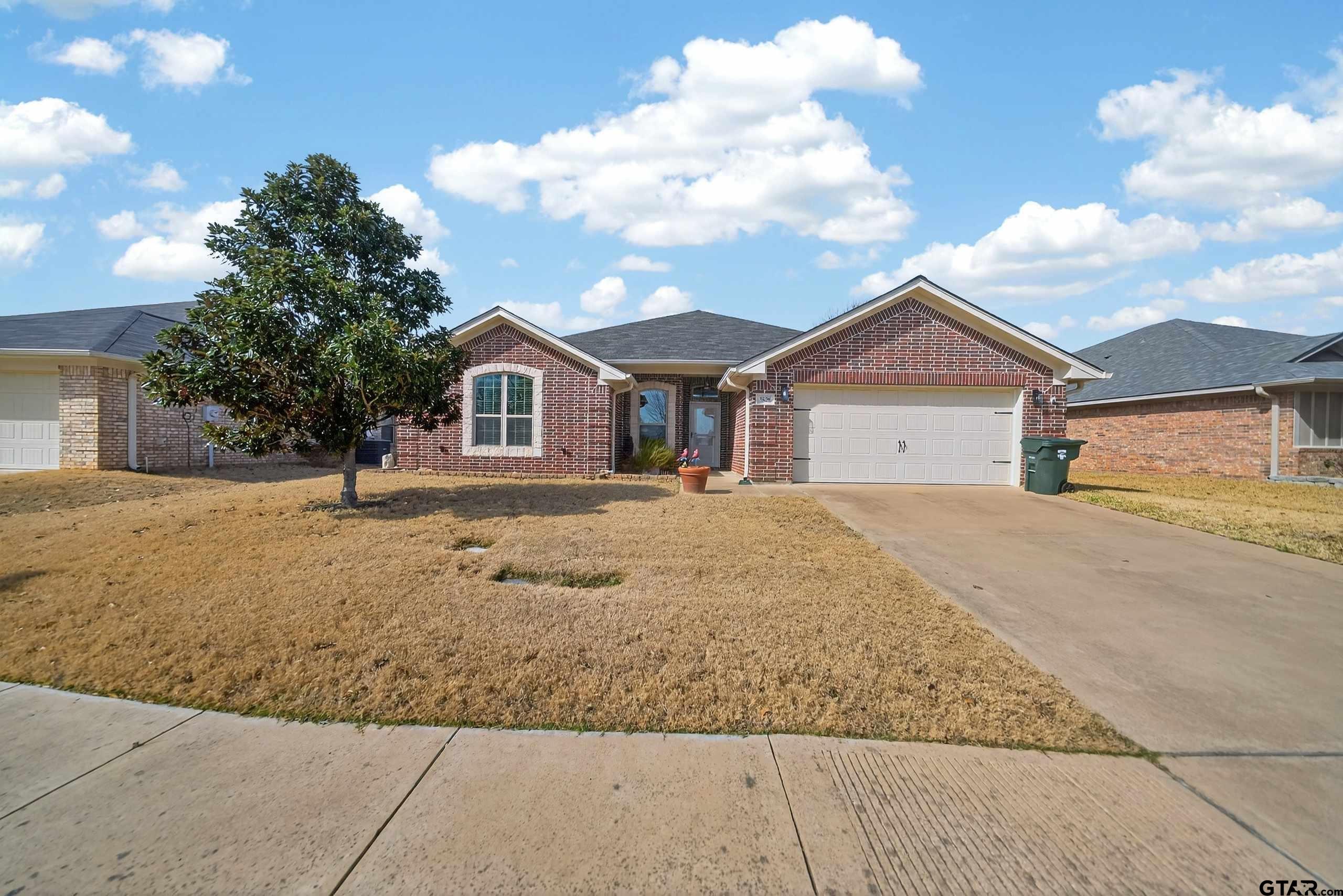 5830 Thompson Place Tyler, TX 75707 - Photo 3 of 35 a front view of a house with a yard