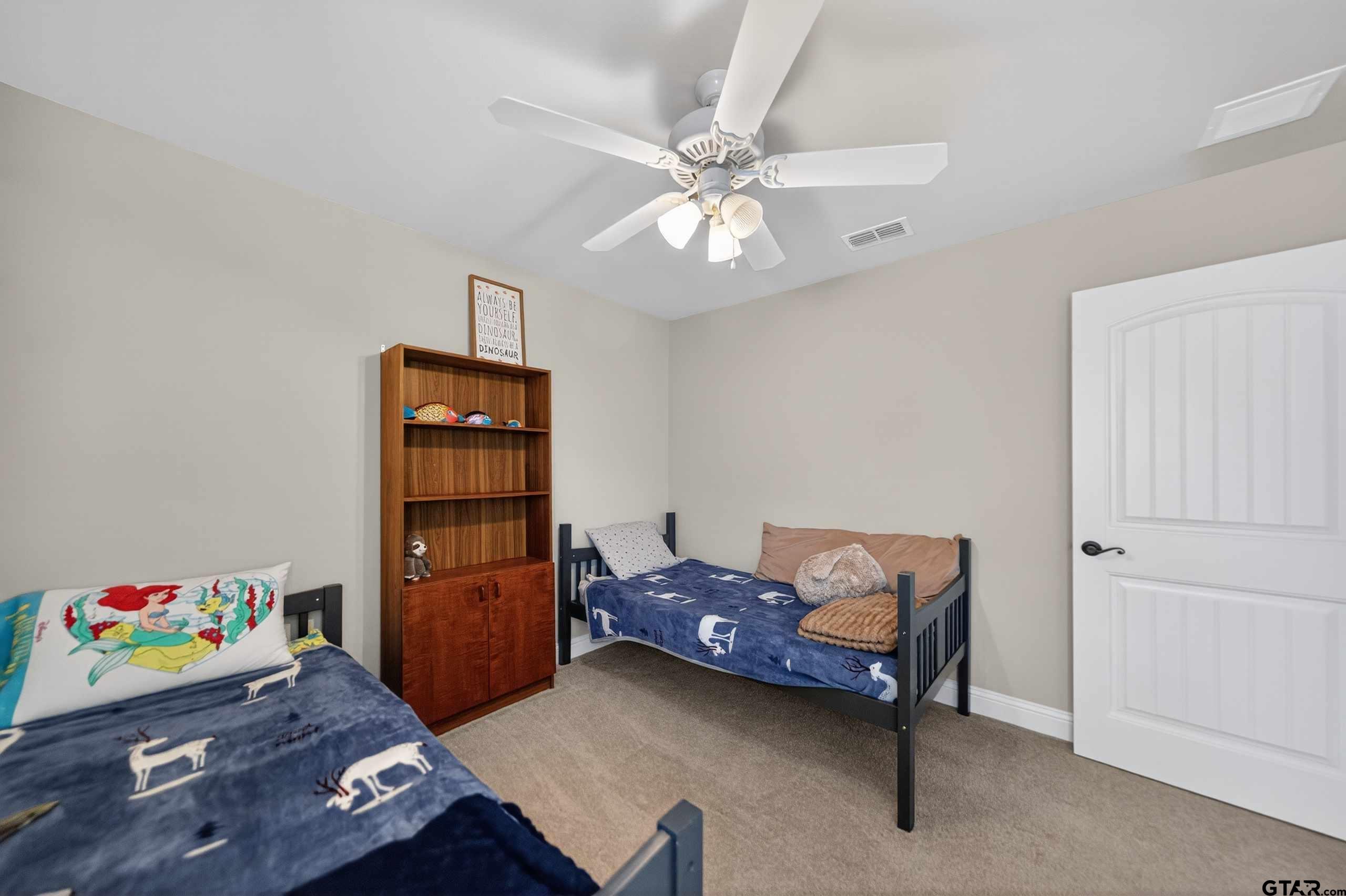 5830 Thompson Place Tyler, TX 75707 - Photo 31 of 35 a bedroom with a bed and wooden floor