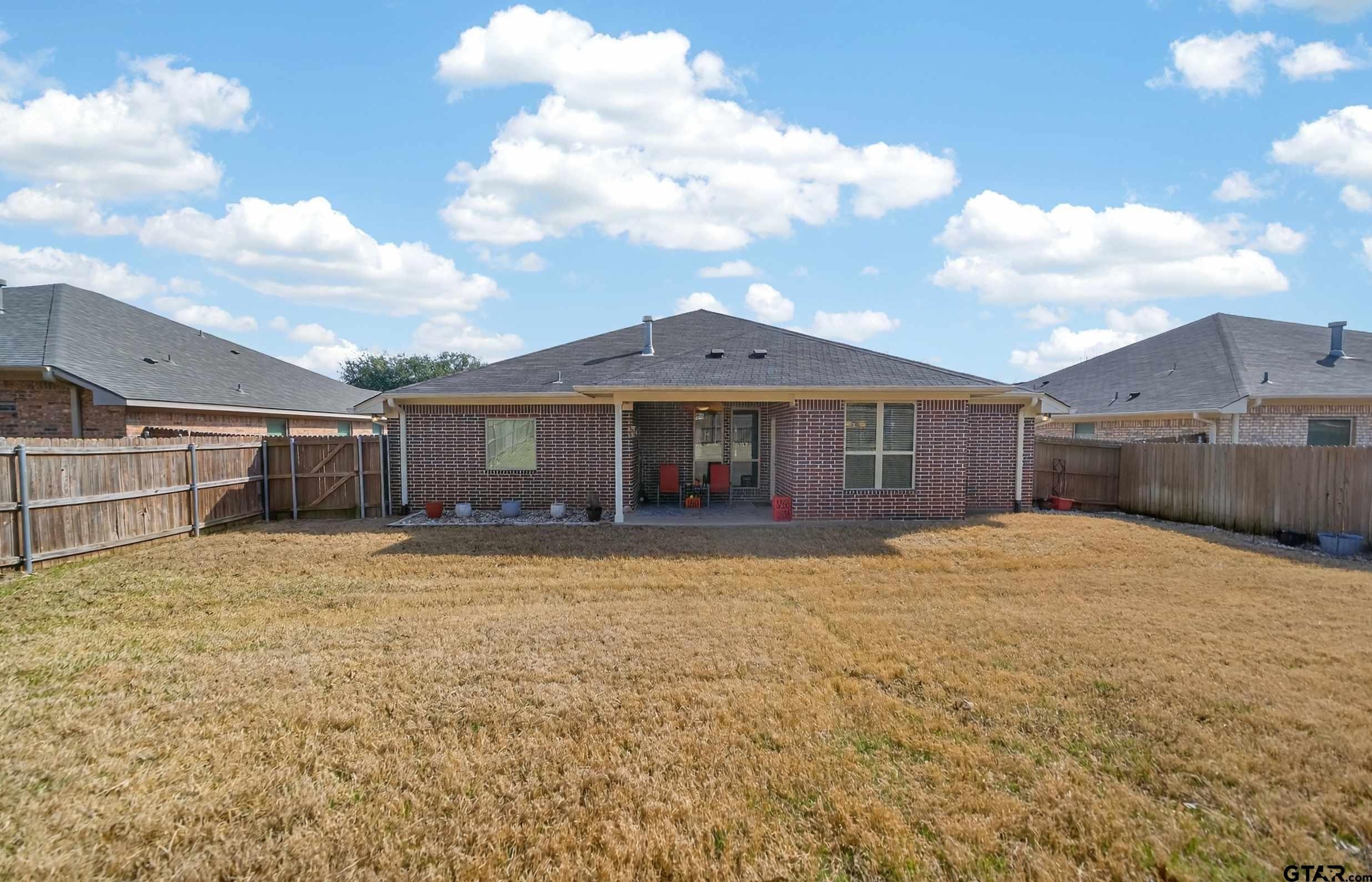 5830 Thompson Place Tyler, TX 75707 - Photo 34 of 35 a front view of a house with a garden