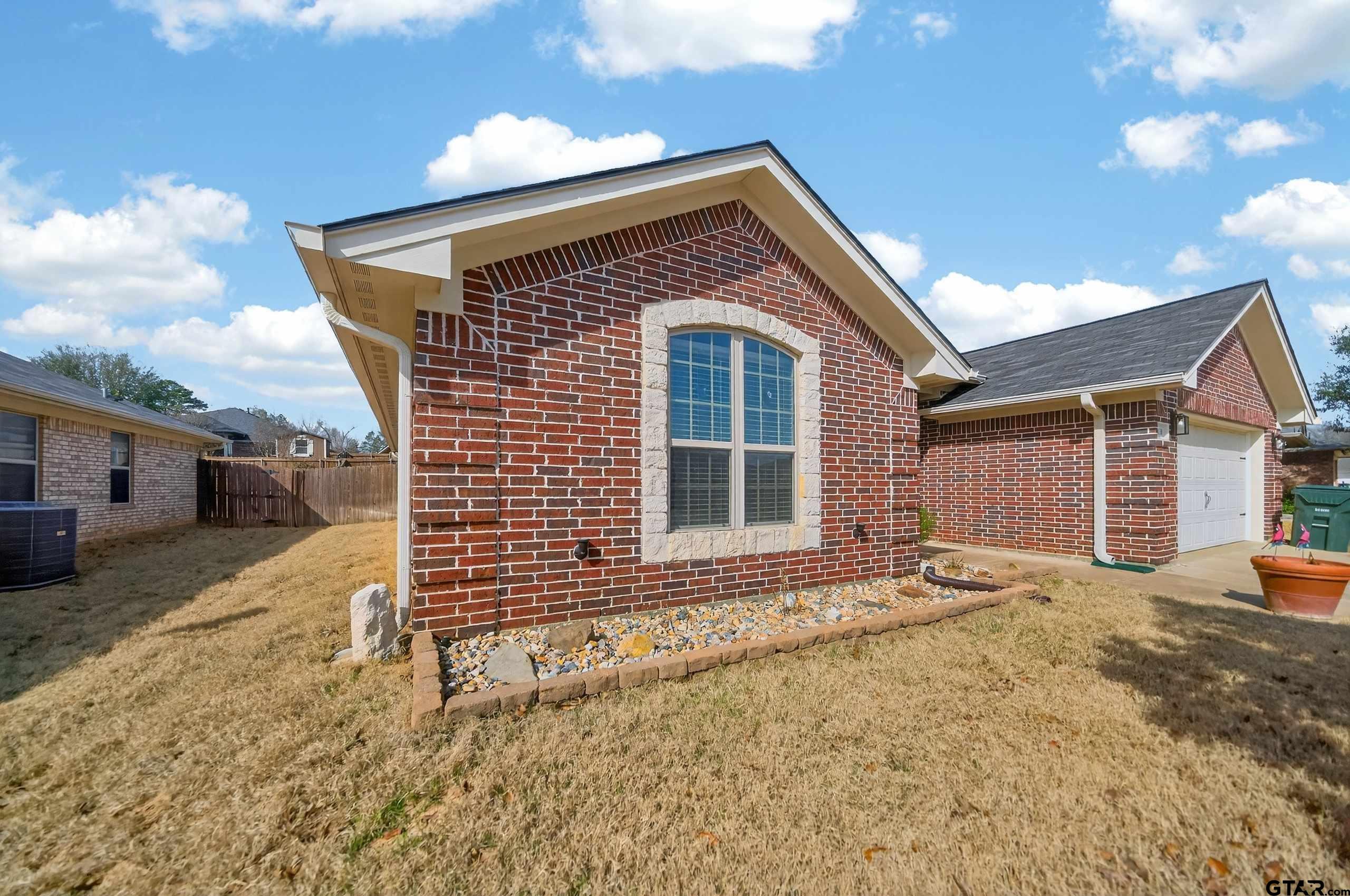 5830 Thompson Place Tyler, TX 75707 - Photo 4 of 35 a front view of a house with a yard