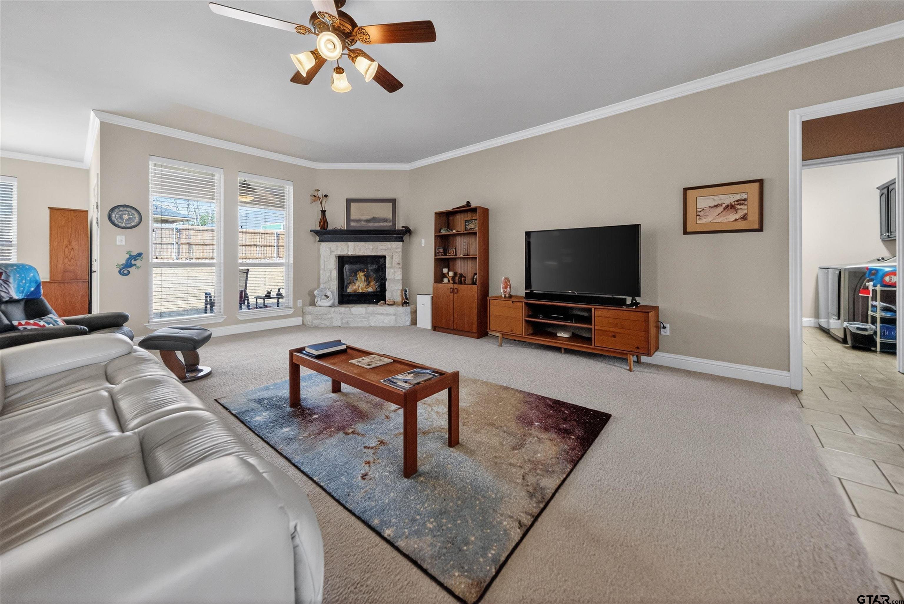 5830 Thompson Place Tyler, TX 75707 - Photo 6 of 35 a living room with furniture and a flat screen tv