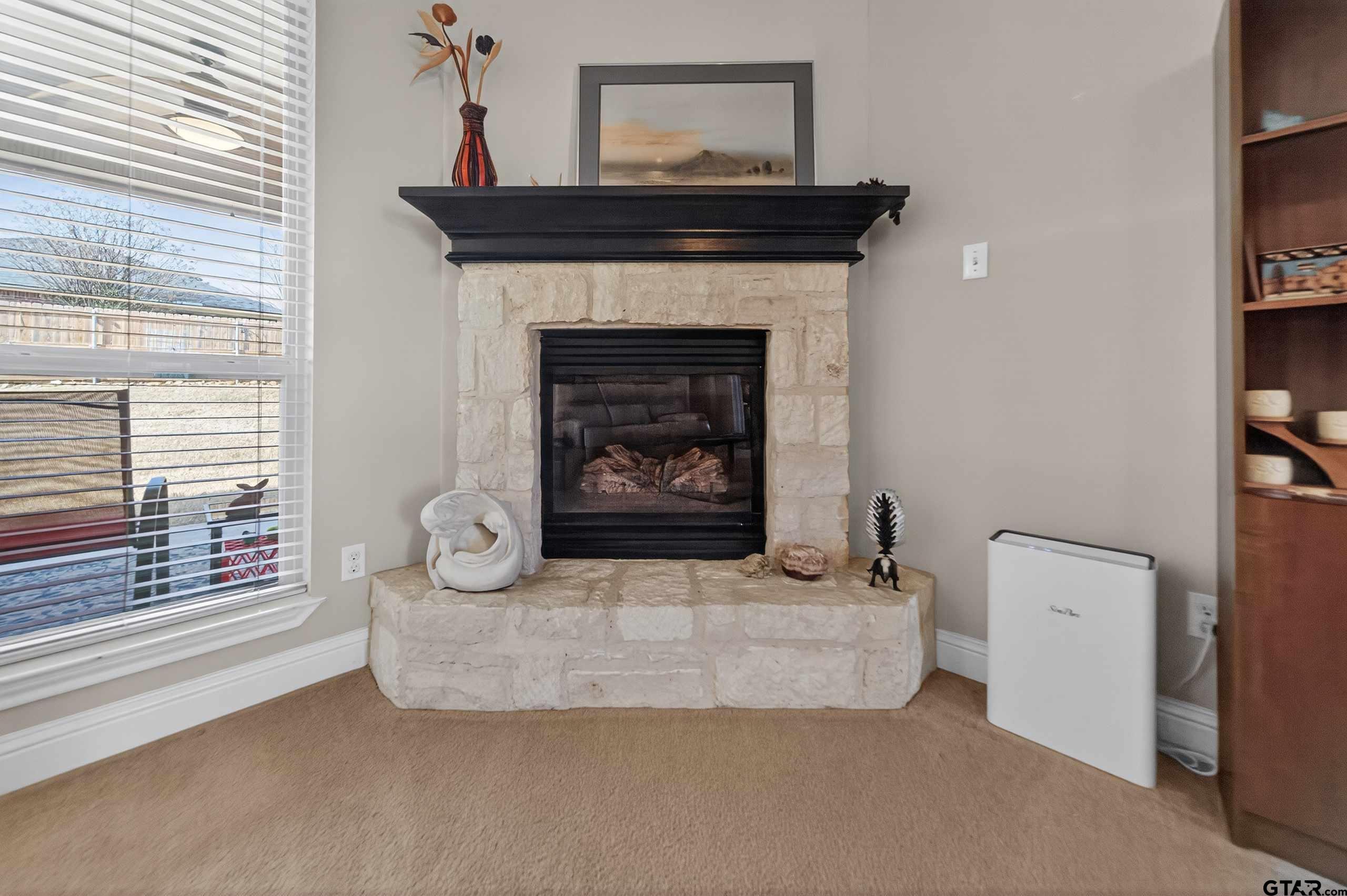 5830 Thompson Place Tyler, TX 75707 - Photo 7 of 35 a living room with furniture and a fireplace