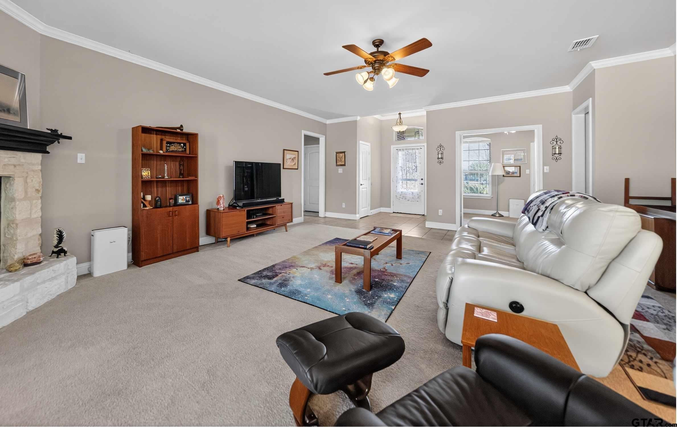 5830 Thompson Place Tyler, TX 75707 - Photo 8 of 35 a living room with furniture and a flat screen tv