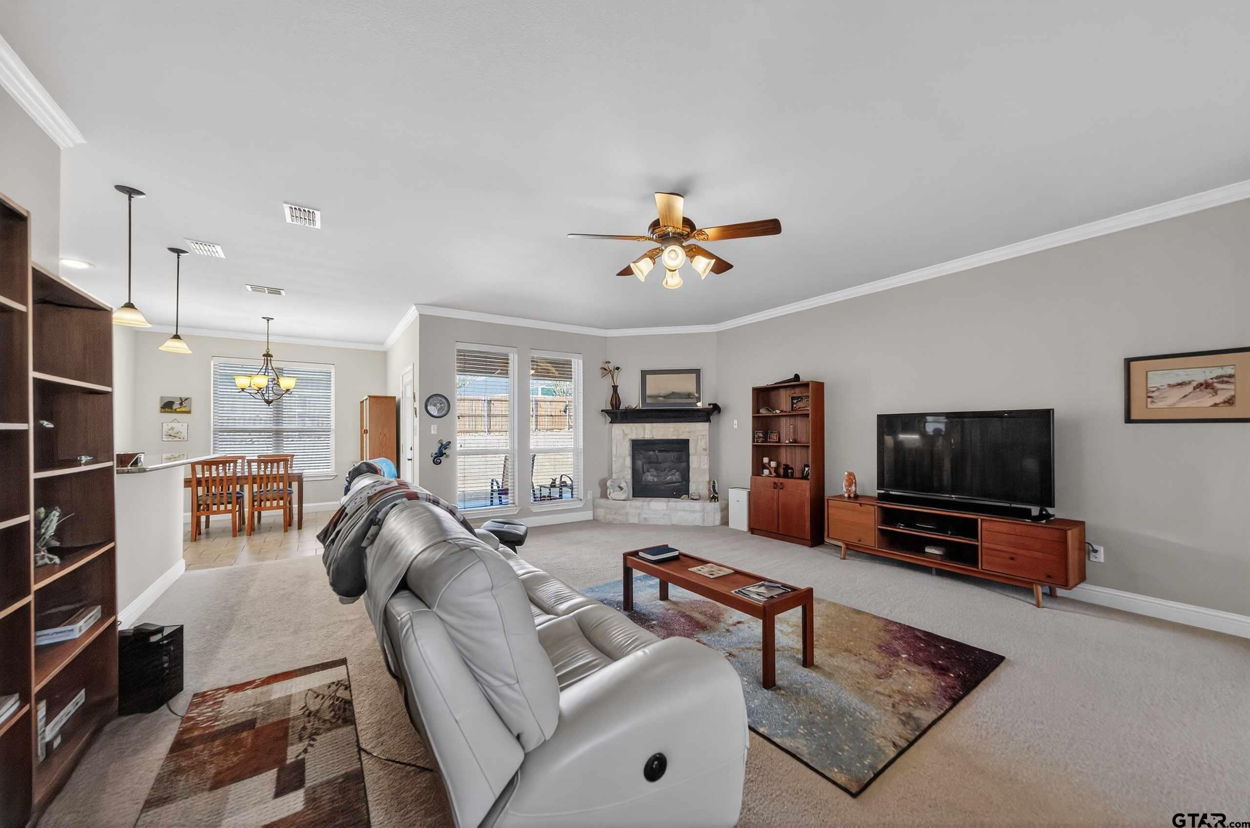 5830 Thompson Place Tyler, TX 75707 - Photo 9 of 35 a living room with furniture and a flat screen tv