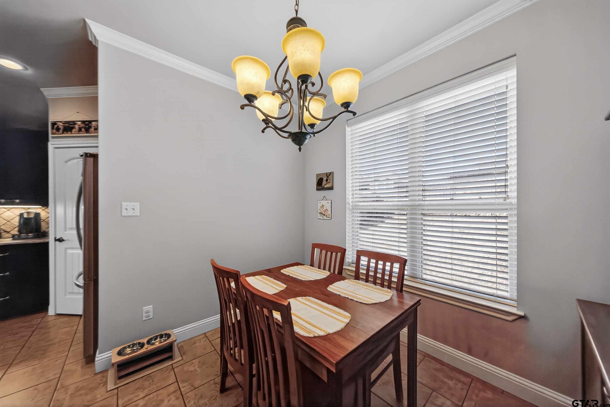 5830 Thompson Place Tyler, TX 75707 - Photo 10 of 35 a view of a dining room with furniture and chandelier