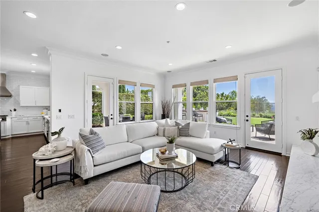 a kitchen with stainless steel appliances kitchen island granite countertop a sink a stove a refrigerator and island with wooden floor