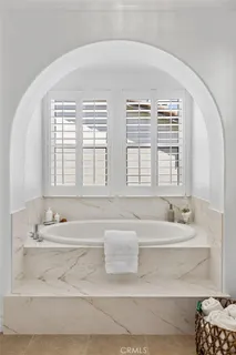 a bathroom with a granite countertop sink mirror toilet and bathtub