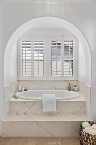 a bathroom with a granite countertop sink mirror toilet and bathtub
