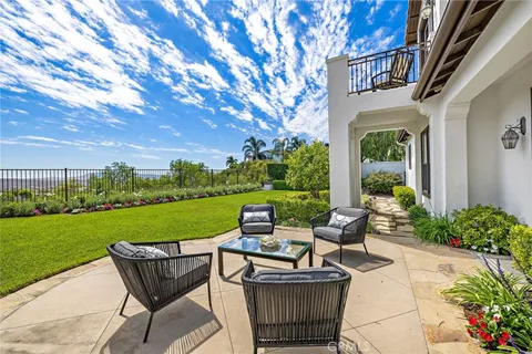 a spacious bedroom with a bed a couch and a large window