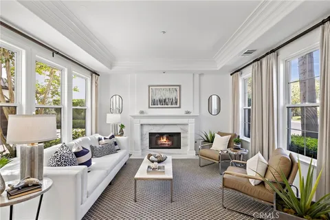 a living room with furniture large window and wooden floor