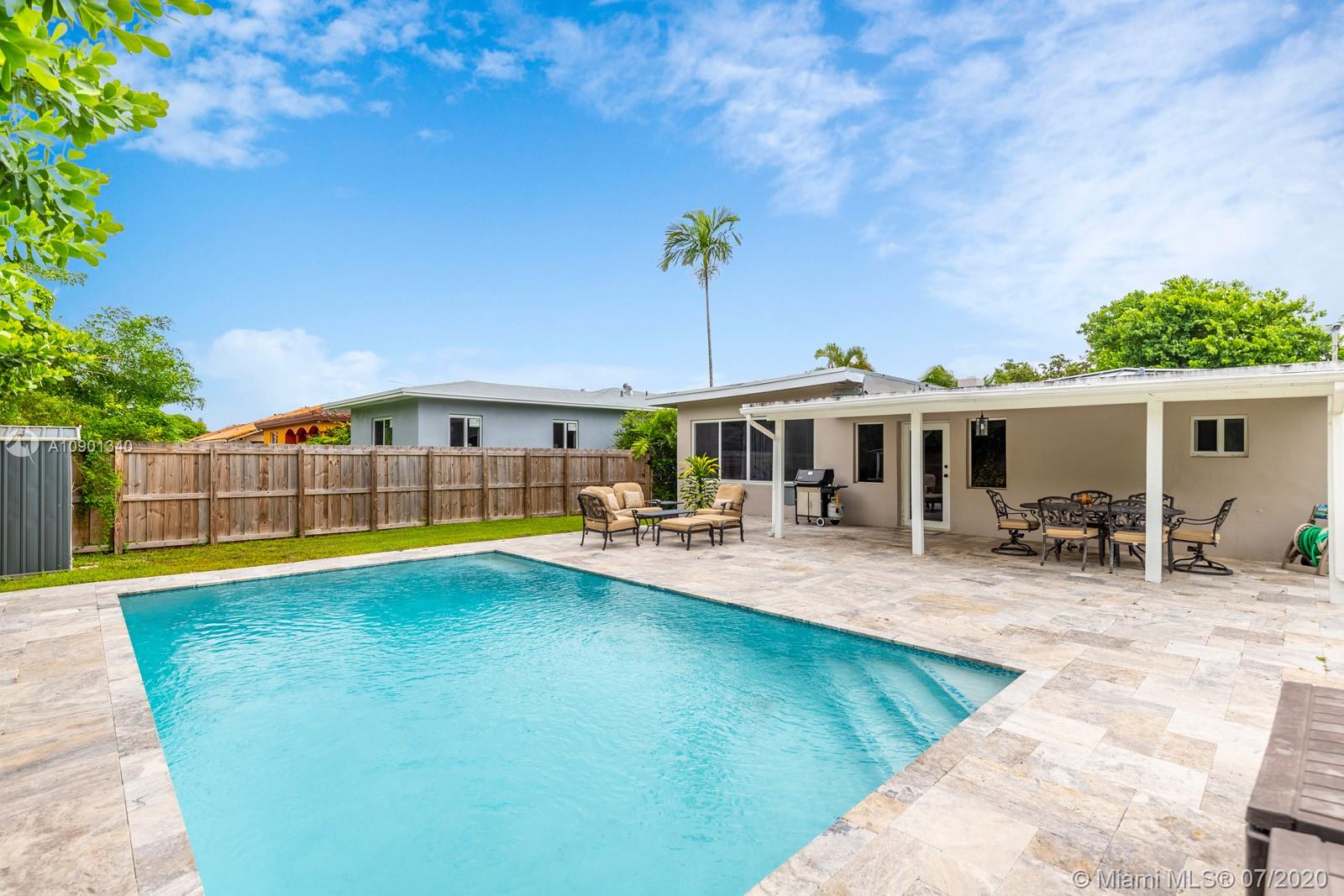 a view of a house with swimming pool and sitting area
