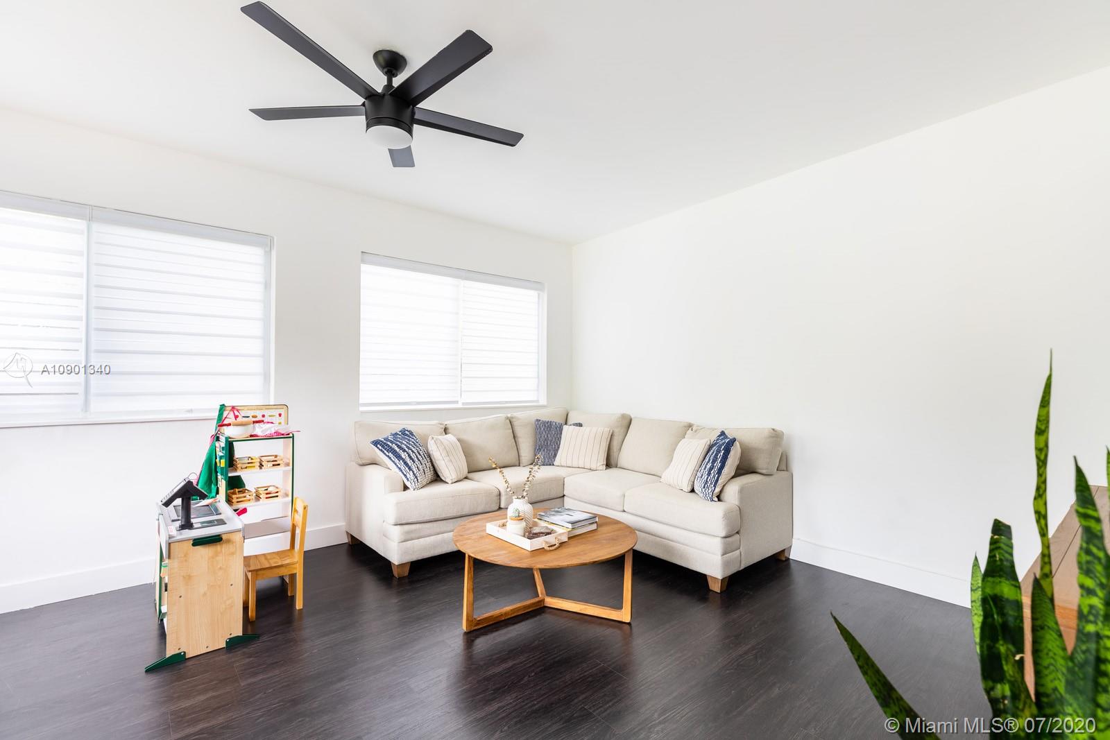6070 Southwest 25th Street Miami, FL 33155 - Photo 13 of 15 a living room with furniture a window and wooden floor