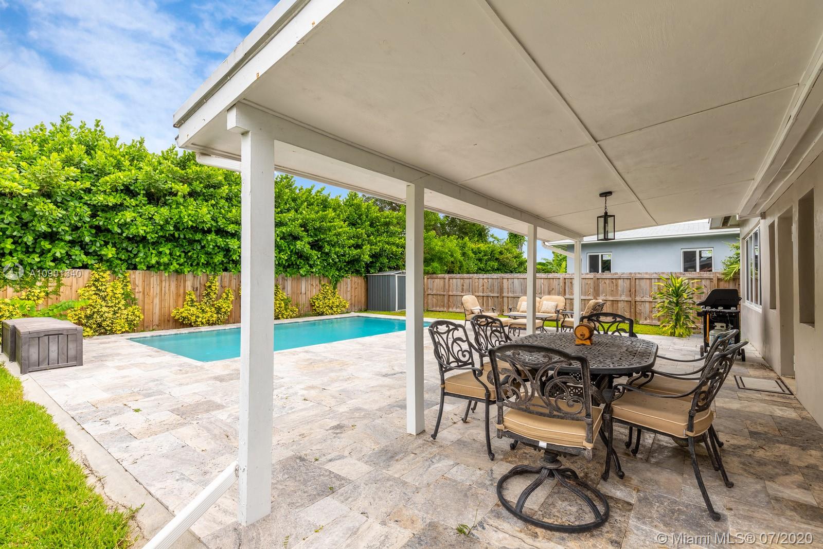 6070 Southwest 25th Street Miami, FL 33155 - Photo 14 of 15 a view of a patio with table and chairs potted plants with wooden floor