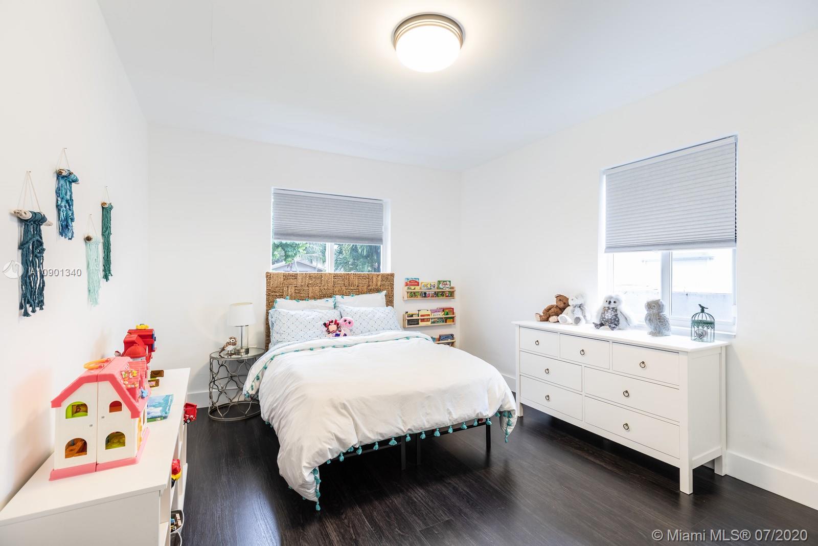 6070 Southwest 25th Street Miami, FL 33155 - Photo 4 of 15 a bedroom with a bed and a dresser