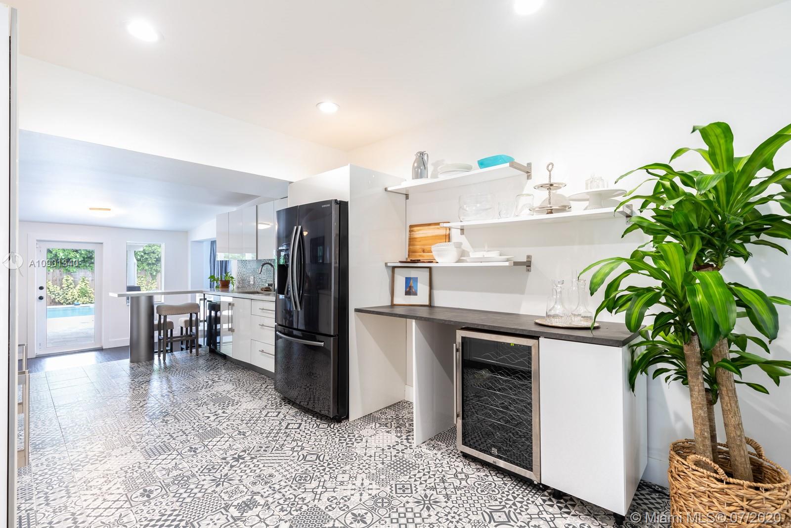 6070 Southwest 25th Street Miami, FL 33155 - Photo 9 of 15 a kitchen with stainless steel appliances a refrigerator a stove a sink a couch and a potted plant
