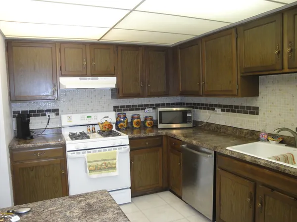 a kitchen with a sink a stove and cabinets