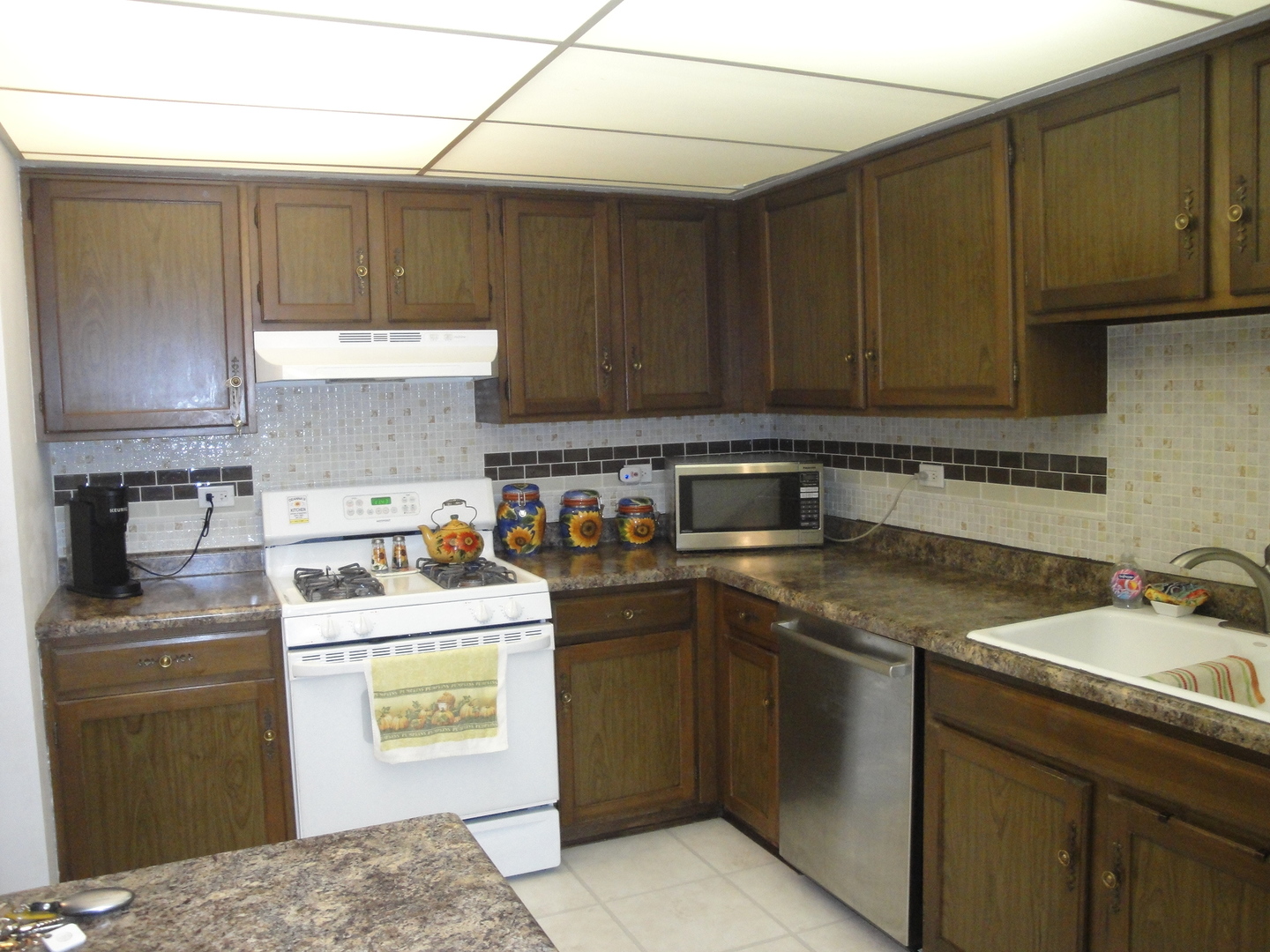 5008 West 122nd Street, Unit 1A Alsip, IL 60803 - Photo 11 of 28 a kitchen with a sink a stove and cabinets