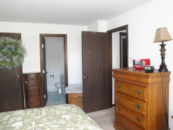 a bedroom with a dresser and a mirror
