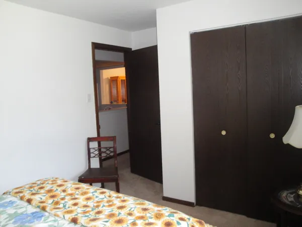 a bedroom with a bed and a dresser