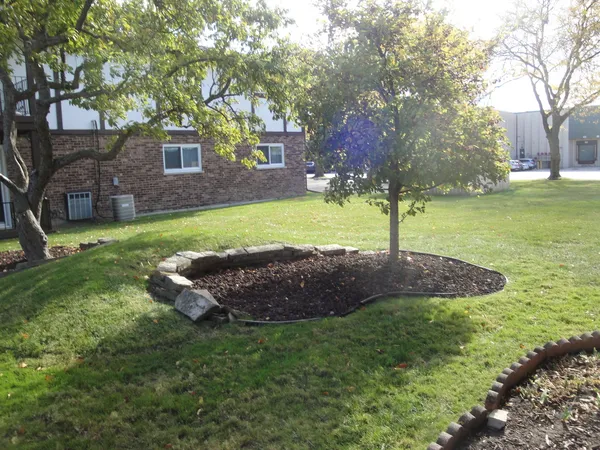 a view of an house with backyard and trees