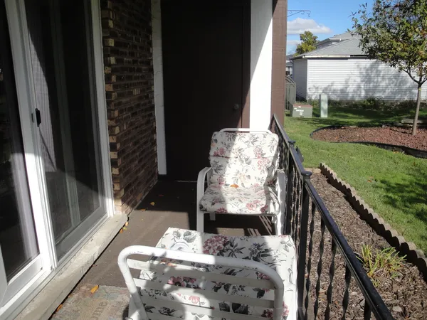 a view of a balcony with chairs and a table