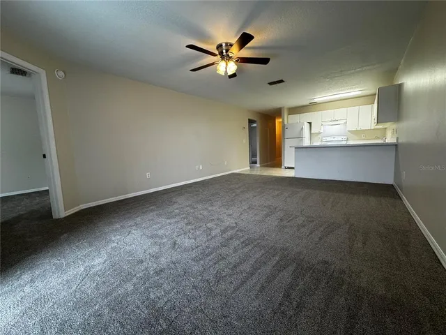an empty room with closet and windows
