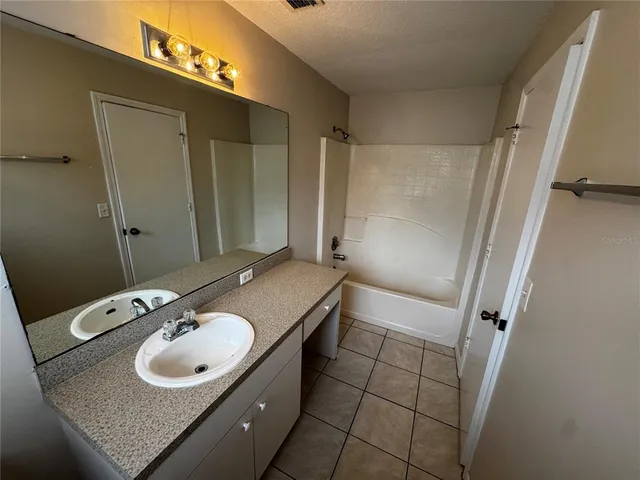 a bathroom with a sink a vanity and a mirror