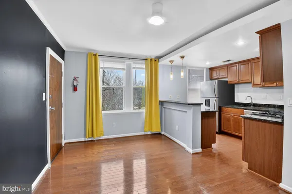 a kitchen with stainless steel appliances granite countertop a refrigerator and a stove top oven