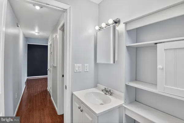 a bathroom with a sink mirror and vanity