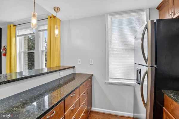 a bathroom with a granite countertop sink and a large mirror
