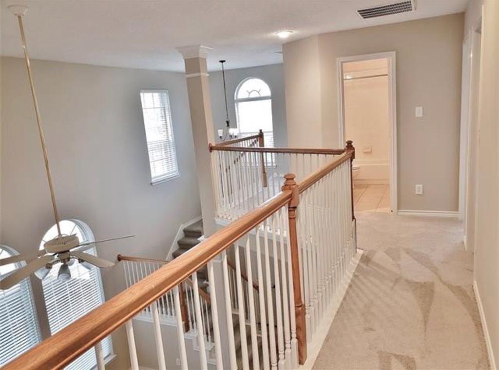 211 Moss Hill Road Irving, TX 75063 - Photo 11 of 14 Corridor with an upstairs landing and light carpet