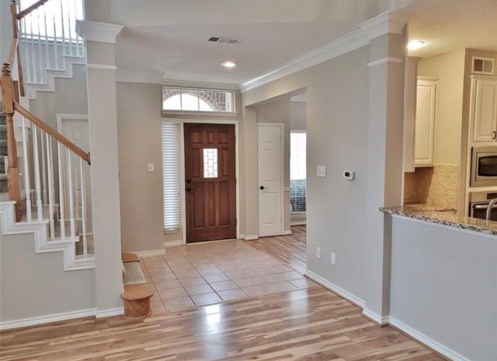 211 Moss Hill Road Irving, TX 75063 - Photo 4 of 14 Entrance foyer with light wood-type flooring and crown molding