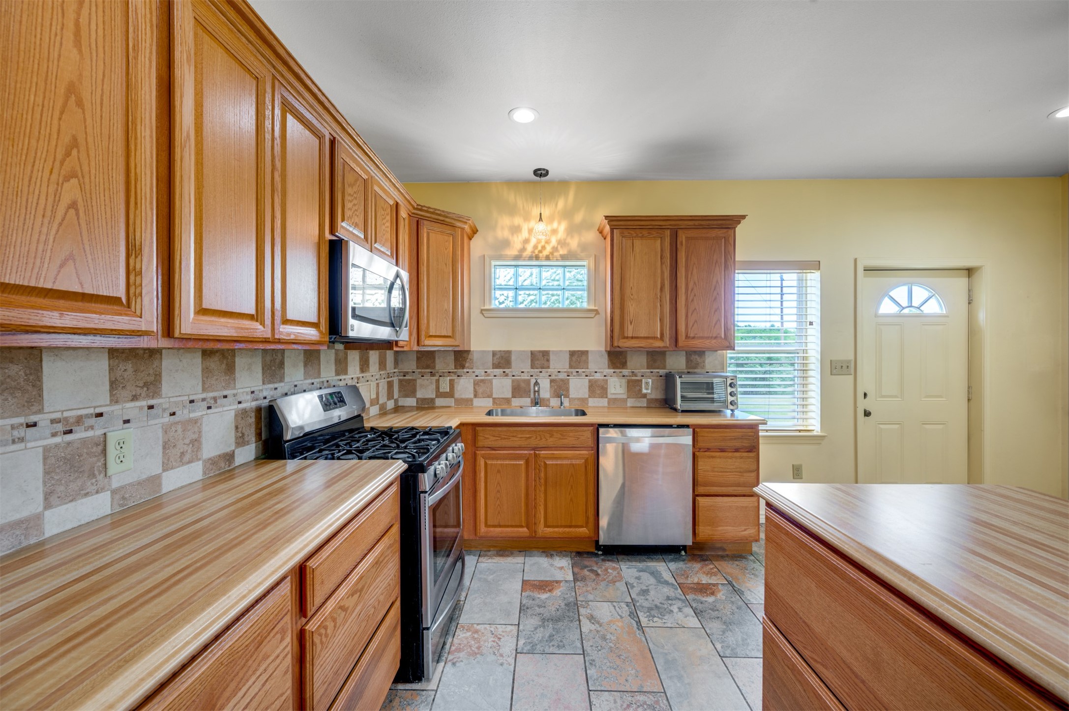 531 County Road 3501 Cuney, TX 75759 - Photo 7 of 35 a kitchen with stainless steel appliances granite countertop wooden cabinets a sink and dishwasher