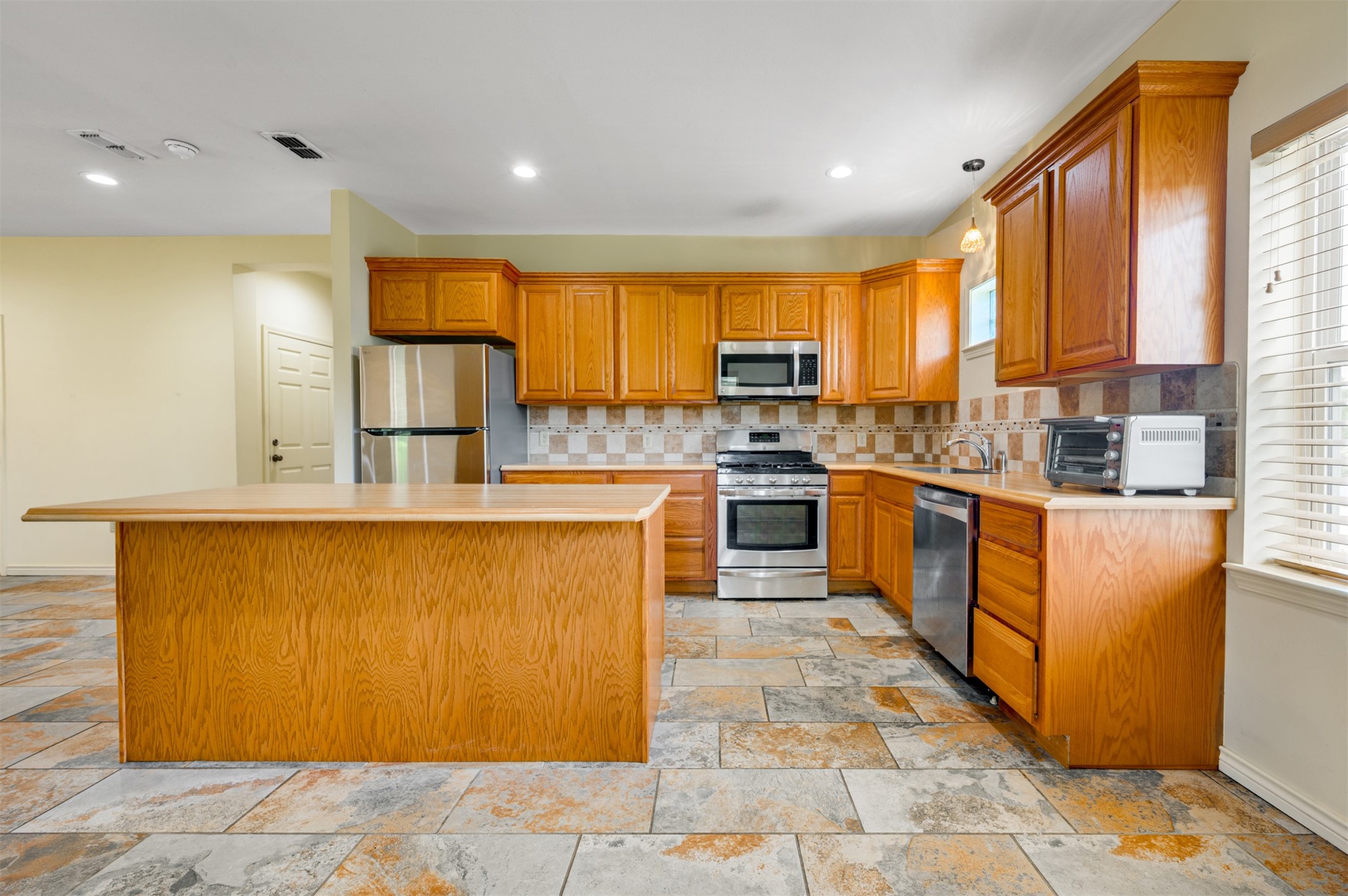531 County Road 3501 Cuney, TX 75759 - Photo 8 of 35 a kitchen with stainless steel appliances granite countertop a stove top oven a sink a dining table and chairs